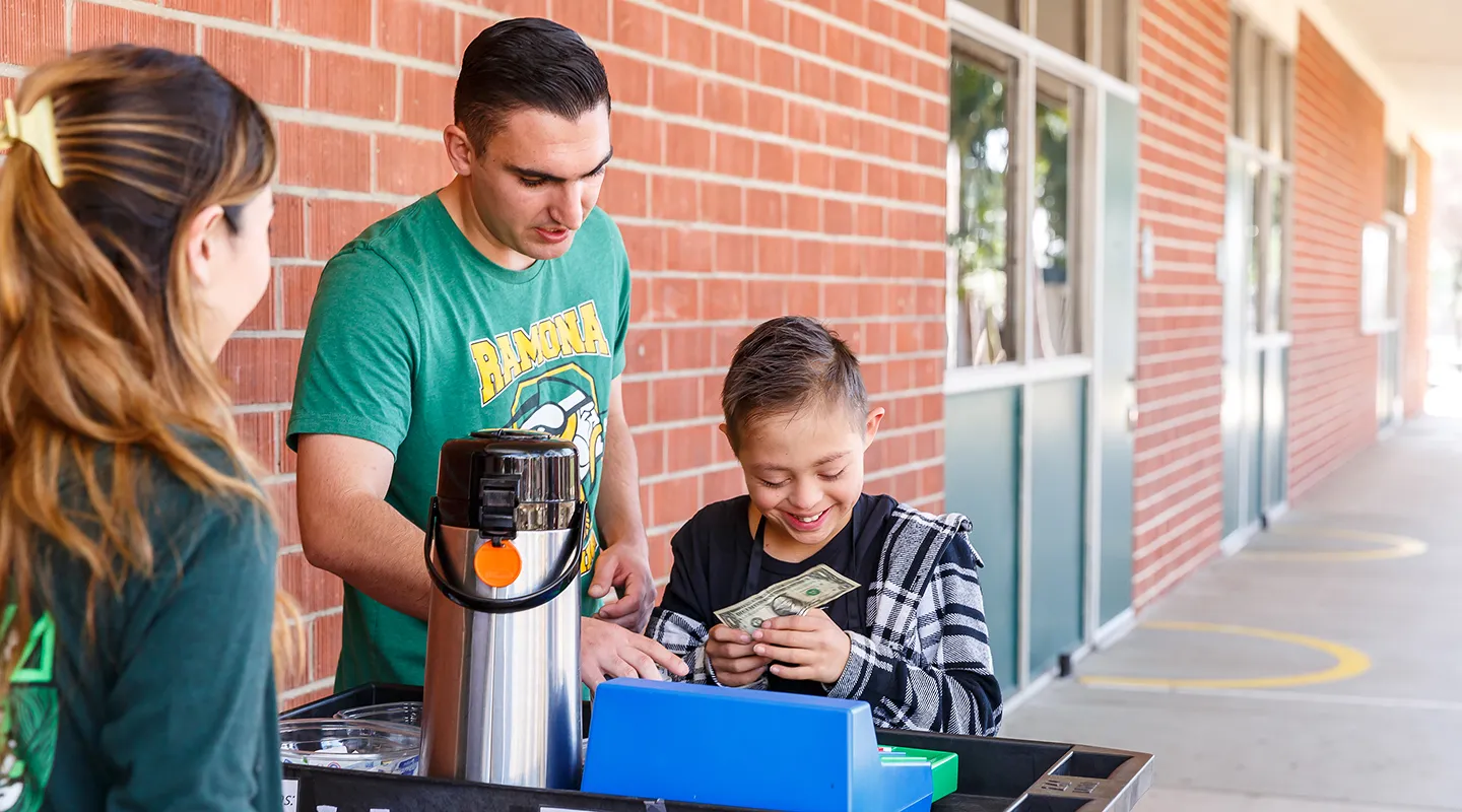 Tucker assists a student in collecting funds