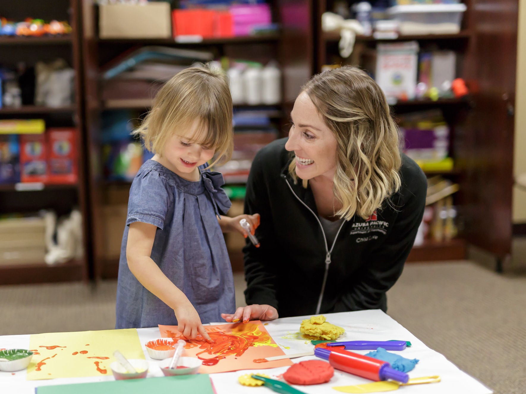 An APU child life student works with a child on developmental play