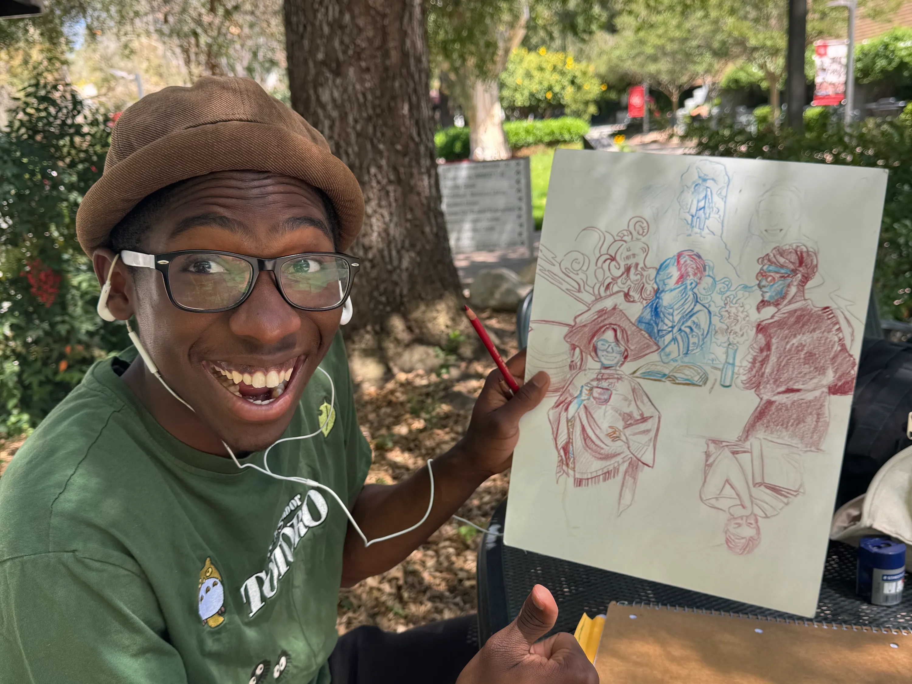 Daniel Medley smiles while holding one of his art pieces.