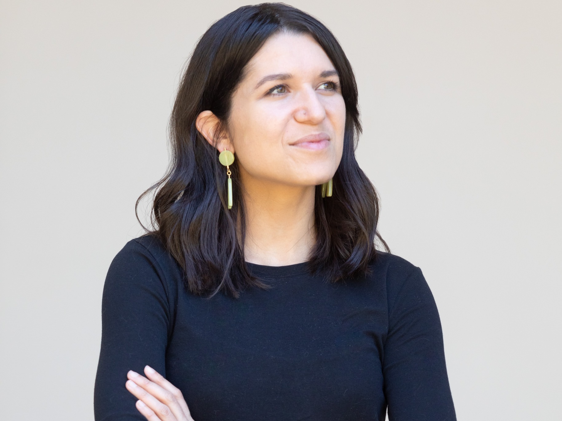 A professional headshot of Kaitlin Hook looking off into the distance.