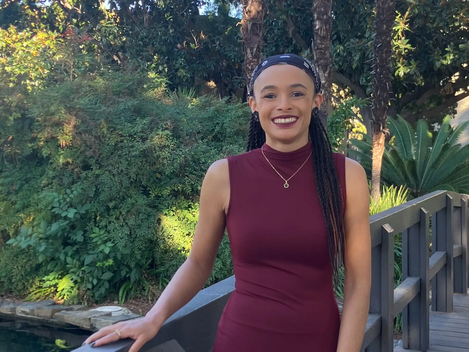 Woman standing smiling on bridge 