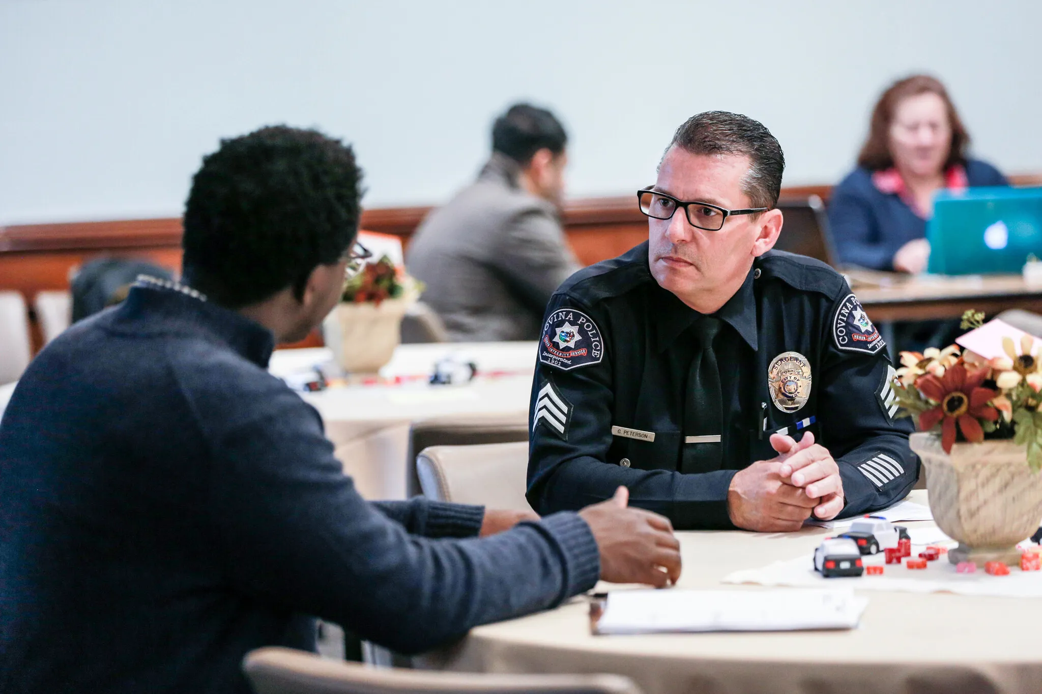student and police man talking during an event