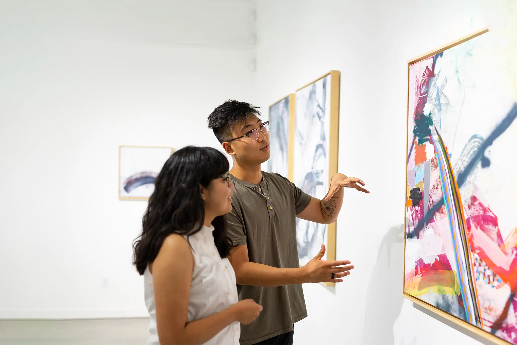 Two students looking at a painting