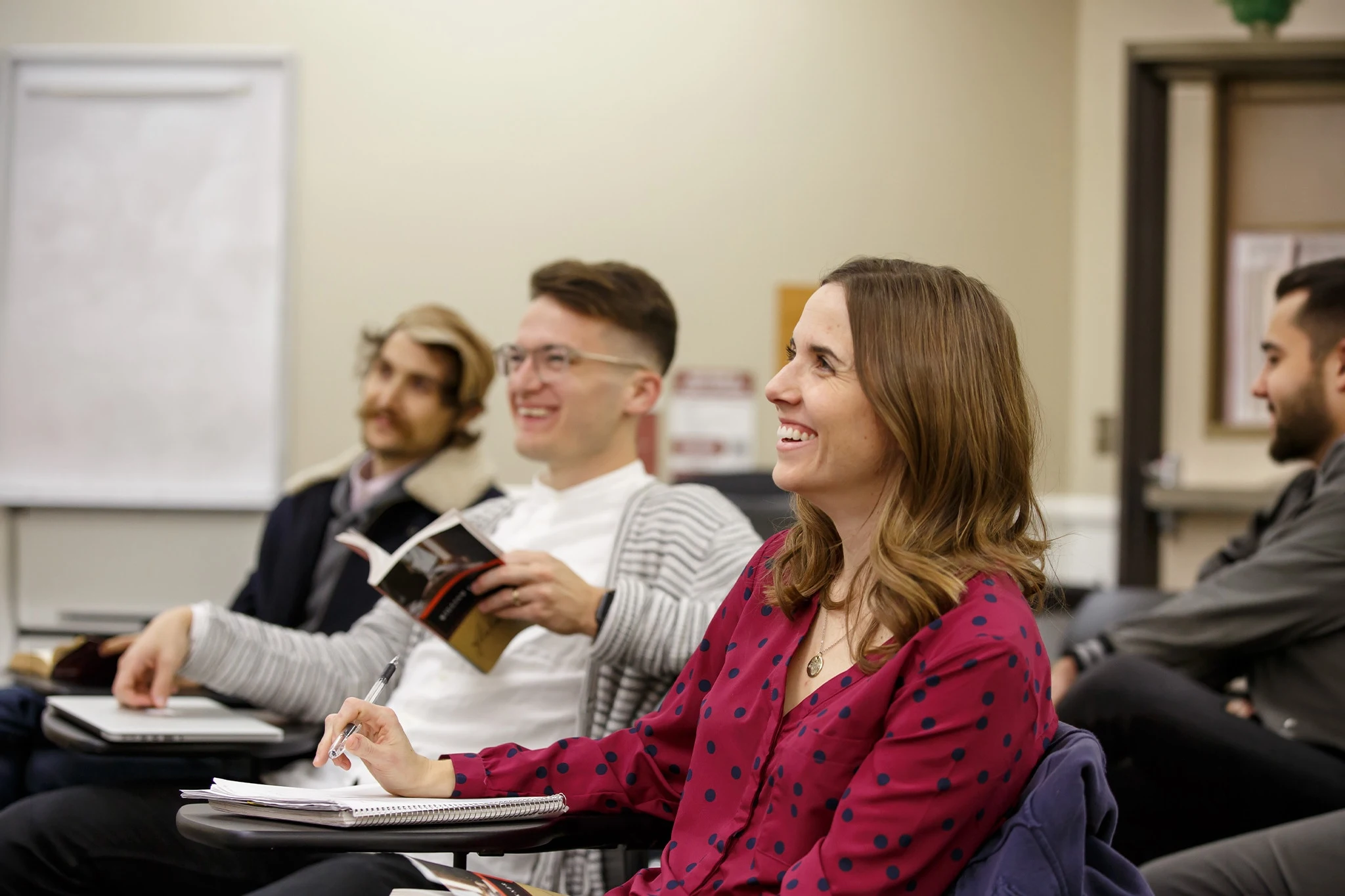 Student laughing in a classroom