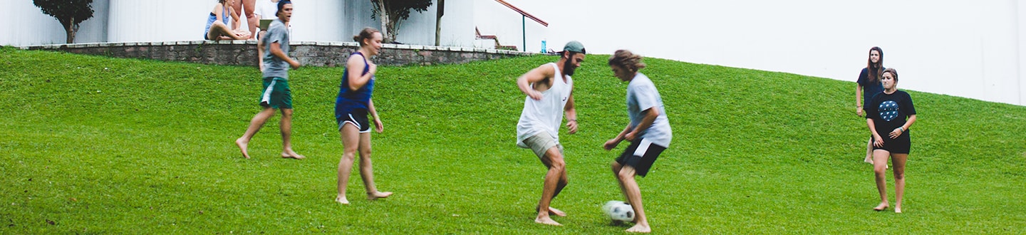 Students playing soccer outdoors