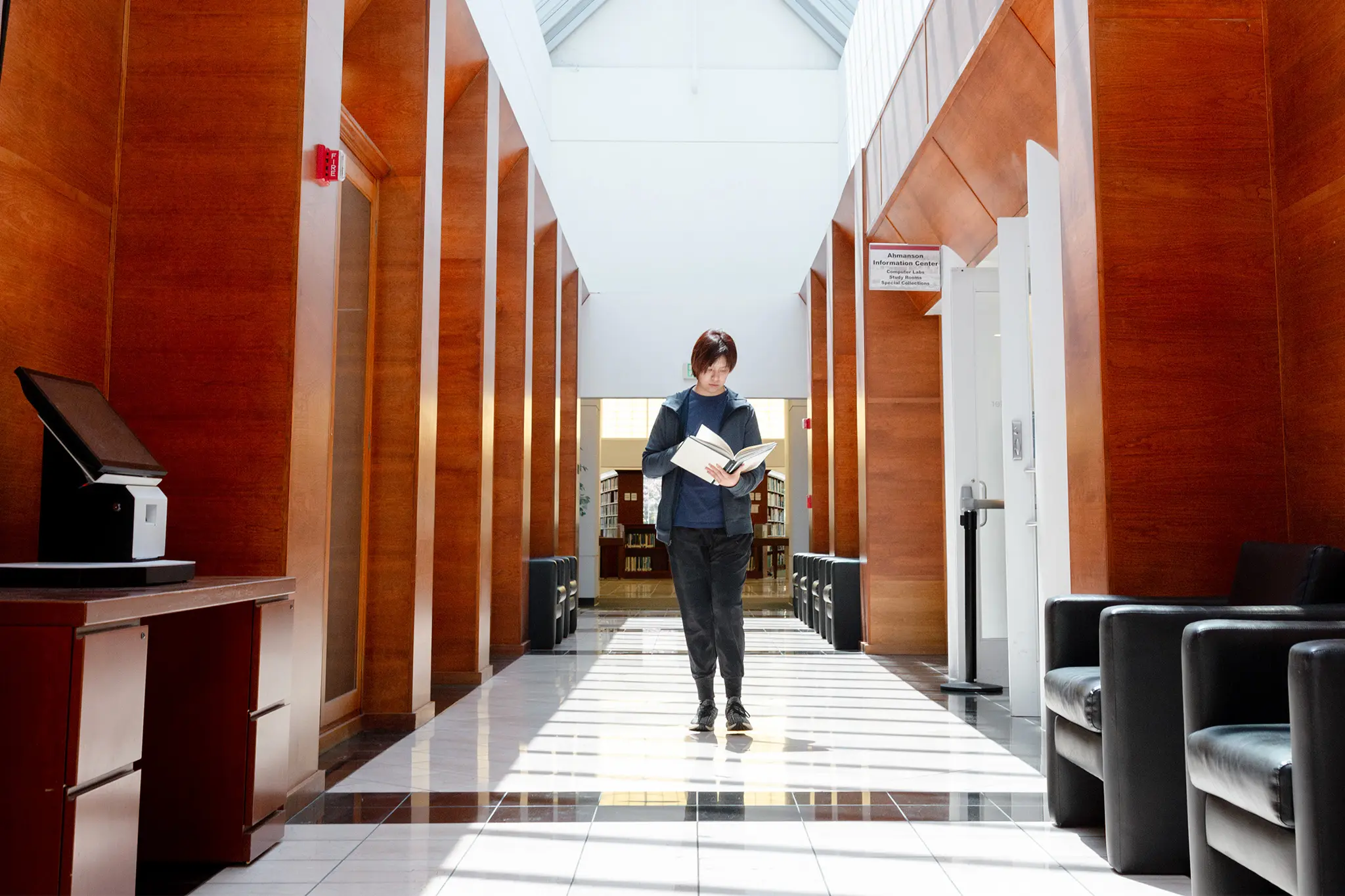 Student reading a book in Azusa Pacific University’s Ahmanson Information Center