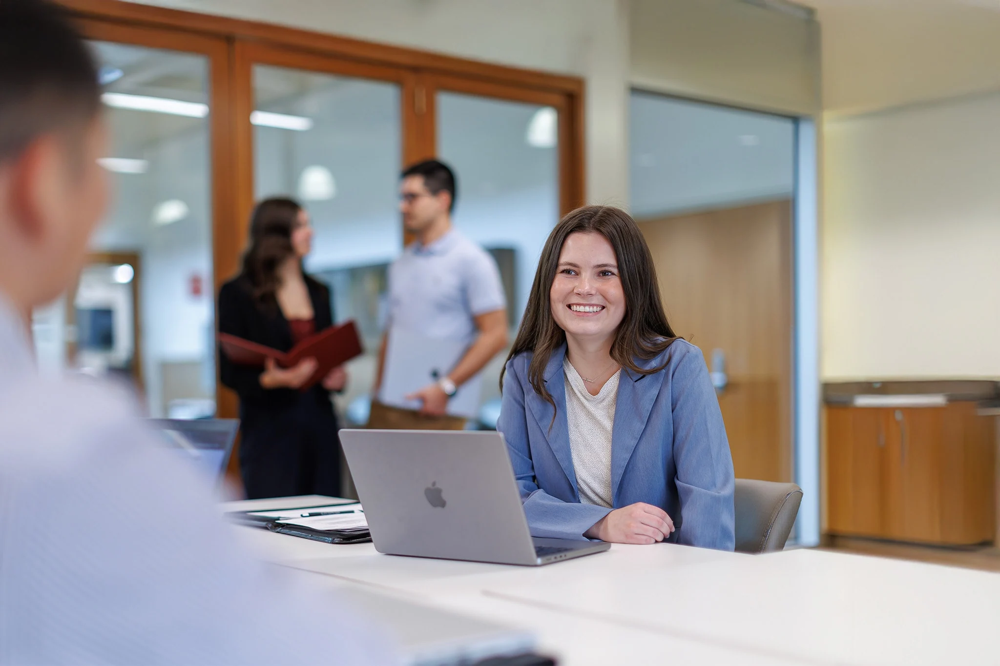 studying smiling smiling while talking to a friend in the classroom