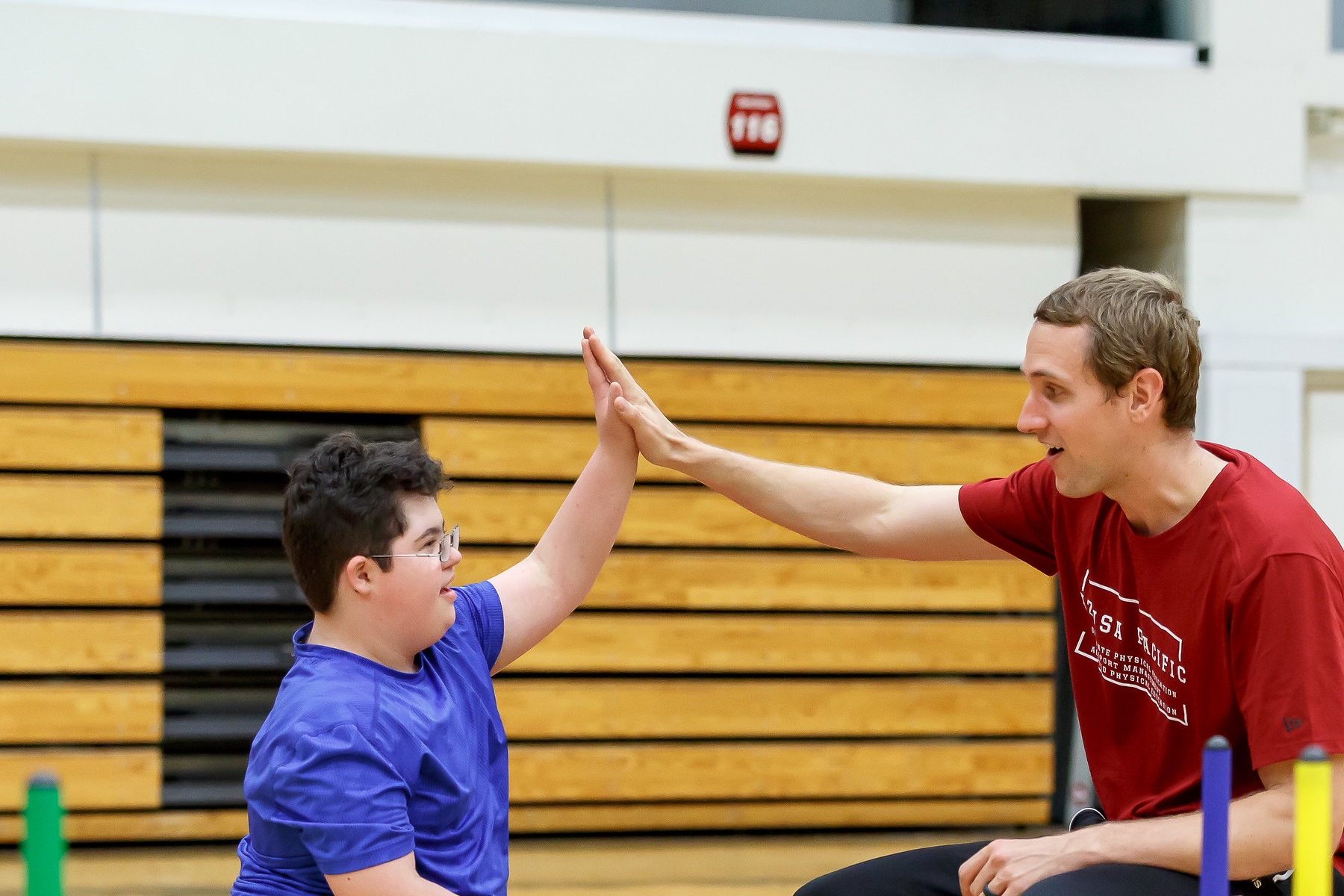 kid playing with professor in class