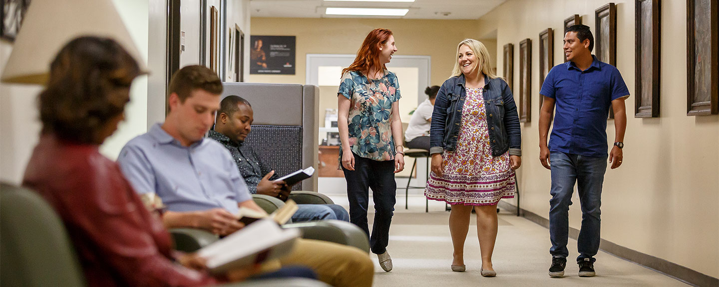 Colleagues chatting in hallway