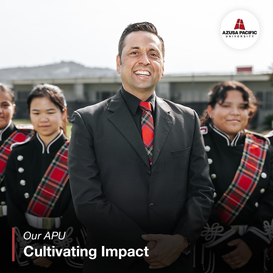 Erick smiling with band members behind him