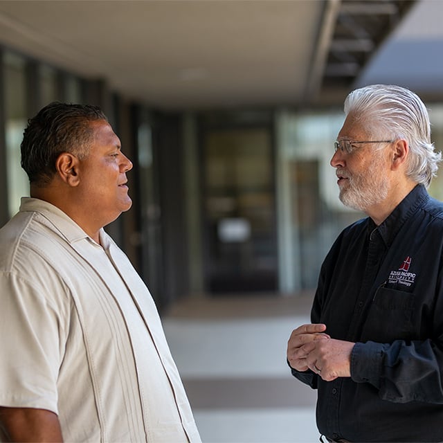 Rene talking to APU faculty member