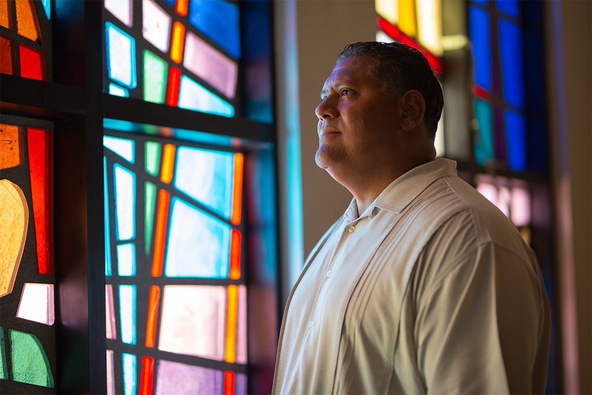 Rene looking through stained glass window